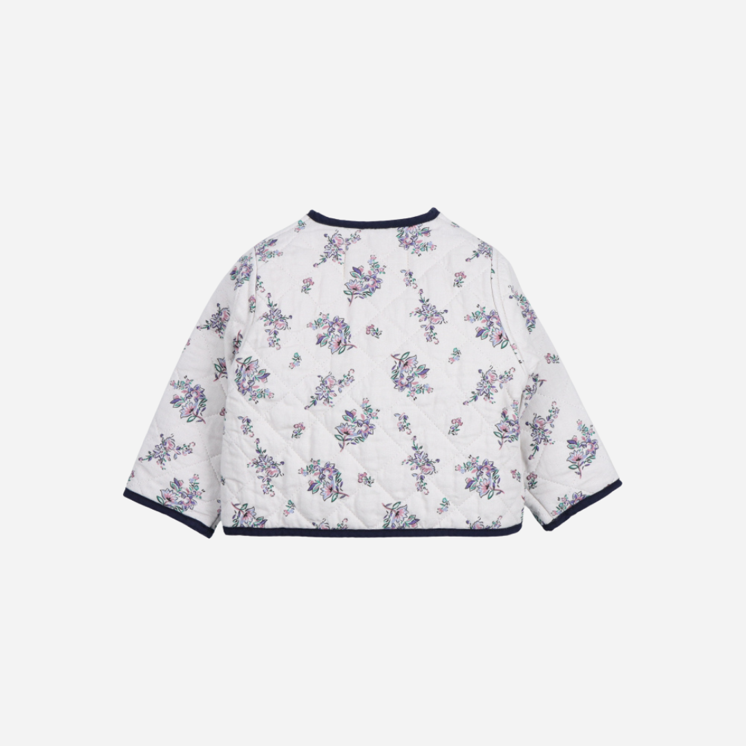 Sold at Bombon shop, this baby girl quilted jacket by The New Society showcases a sweet floral print with wooden buttons and contrasting navy trim—perfect for layering in cooler weather while adding a classic touch. back