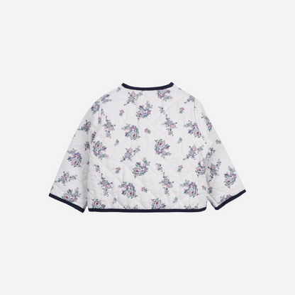 Sold at Bombon shop, this baby girl quilted jacket by The New Society showcases a sweet floral print with wooden buttons and contrasting navy trim—perfect for layering in cooler weather while adding a classic touch. back