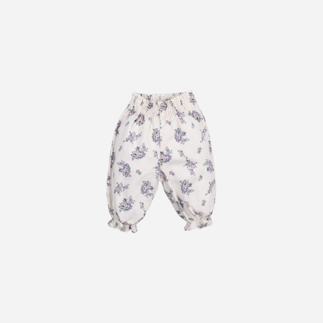 Sold at Bombon shop, these baby girl pants by The New Society feature an all-over floral print, an elastic waistband for easy dressing, and gathered ruffle hems for a comfortable and playful everyday outfit. front