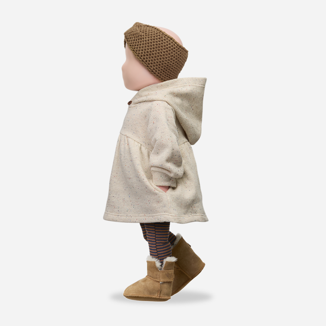 Sold at Bombon shop, designed by 1+ in the family — long-sleeve speckled beige baby dress with gathered waist and hood, shown flat on white background. mannequin