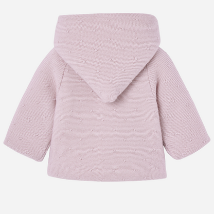 Sold at Bombon shop, designed by Paz Rodriguez, pink knit hooded baby coat with dot texture and button-up front from the Erizos collection.