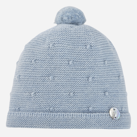 Sold at Bombon shop, designed by Paz Rodriguez, light blue knit baby hat with pom-pom and delicate textured bobble details.