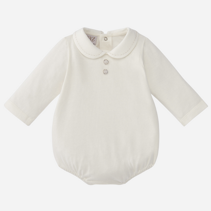 Sold at Bombon shop, designed by Paz Rodriguez. Ivory long-sleeve baby body with Peter Pan collar and two chest buttons.