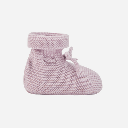 Sold at Bombon shop, designed by Paz Rodriguez. Pale pink knit baby booties with tie detail and rolled cuff side view