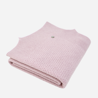 Sold at Bombon shop, designed by Paz Rodriguez, folded pale pink baby blanket with scalloped detailing.