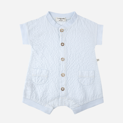 Sold at Bombon Shop, designed by 1+ in the family, misty blue baby overall with front button detail and textured cotton fabric.