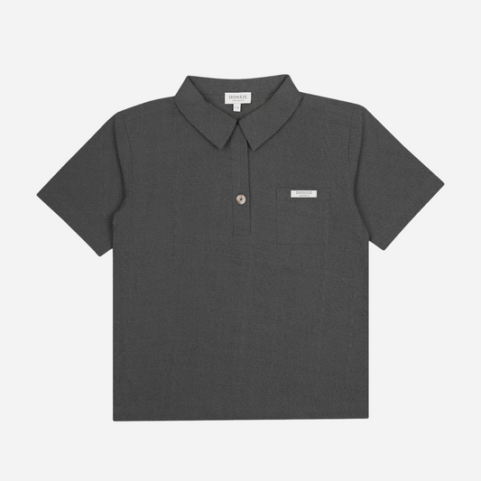 Sold at Bombon shop, designed by Donsje from Amsterdam, this baby and toddler short sleeve button down shirt in a cloudy grey color for boys is the perfect pre-fall and transition piece. front view