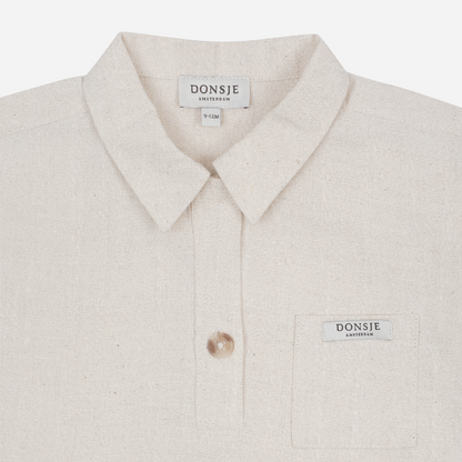 Sold at Bombon shop, designed by Donsje from Amsterdam, this baby and toddler short sleeve button down shirt in a warm white color for boys is the perfect pre-fall and transition piece. top view