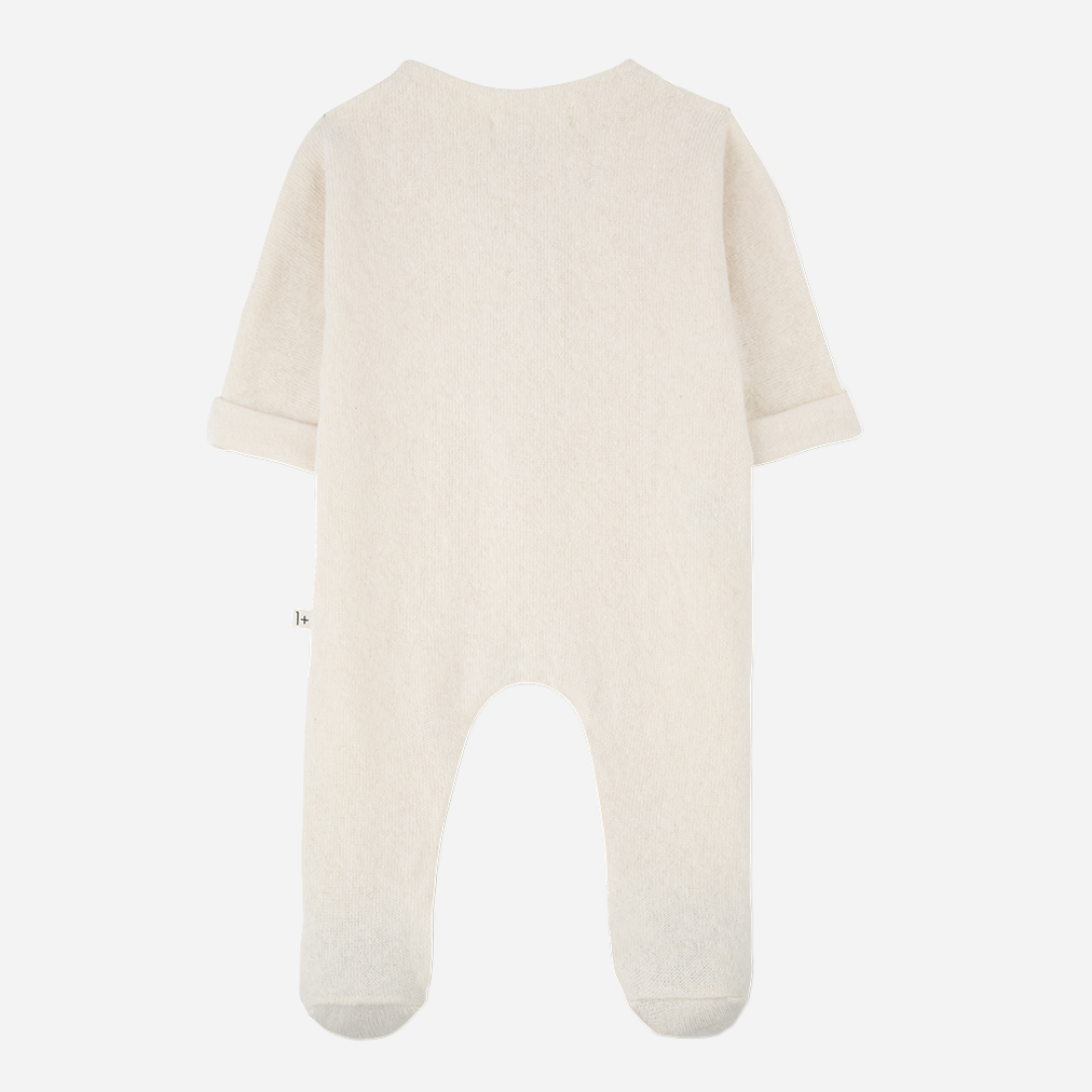 Sold at Bombon shop, designed by 1+ in the family — ecru footed baby jumpsuit with button placket and long sleeves. front