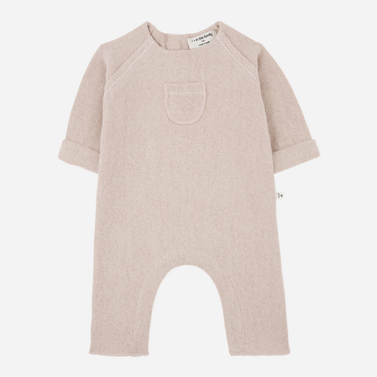 Sold at Bombon shop, designed by 1+ in the family — nude baby jumpsuit with long sleeves, chest pocket, and turned cuffs. front