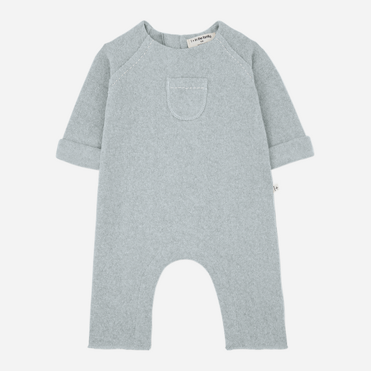 Sold at Bombon shop, designed by 1+ in the family — nuvola blue baby jumpsuit with long sleeves, patch pocket, and rolled cuffs. front