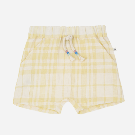 Sold at Bombon Shop, designed by 1+ in the family, lemon check baby bermuda shorts with elastic waistband and soft cotton fabric.