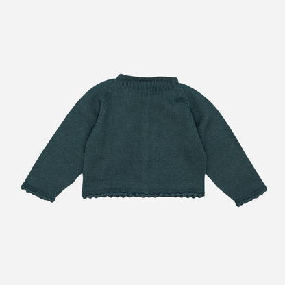 Sold at Bombon shop, designed by Fina Ejerique, a forest-green knit baby cardigan with scalloped trim and front buttons. back