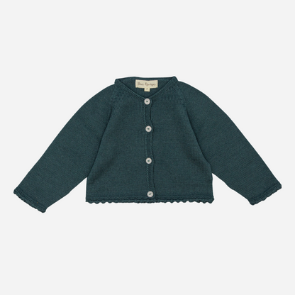 Sold at Bombon shop, designed by Fina Ejerique, a forest-green knit baby cardigan with scalloped trim and front buttons. front