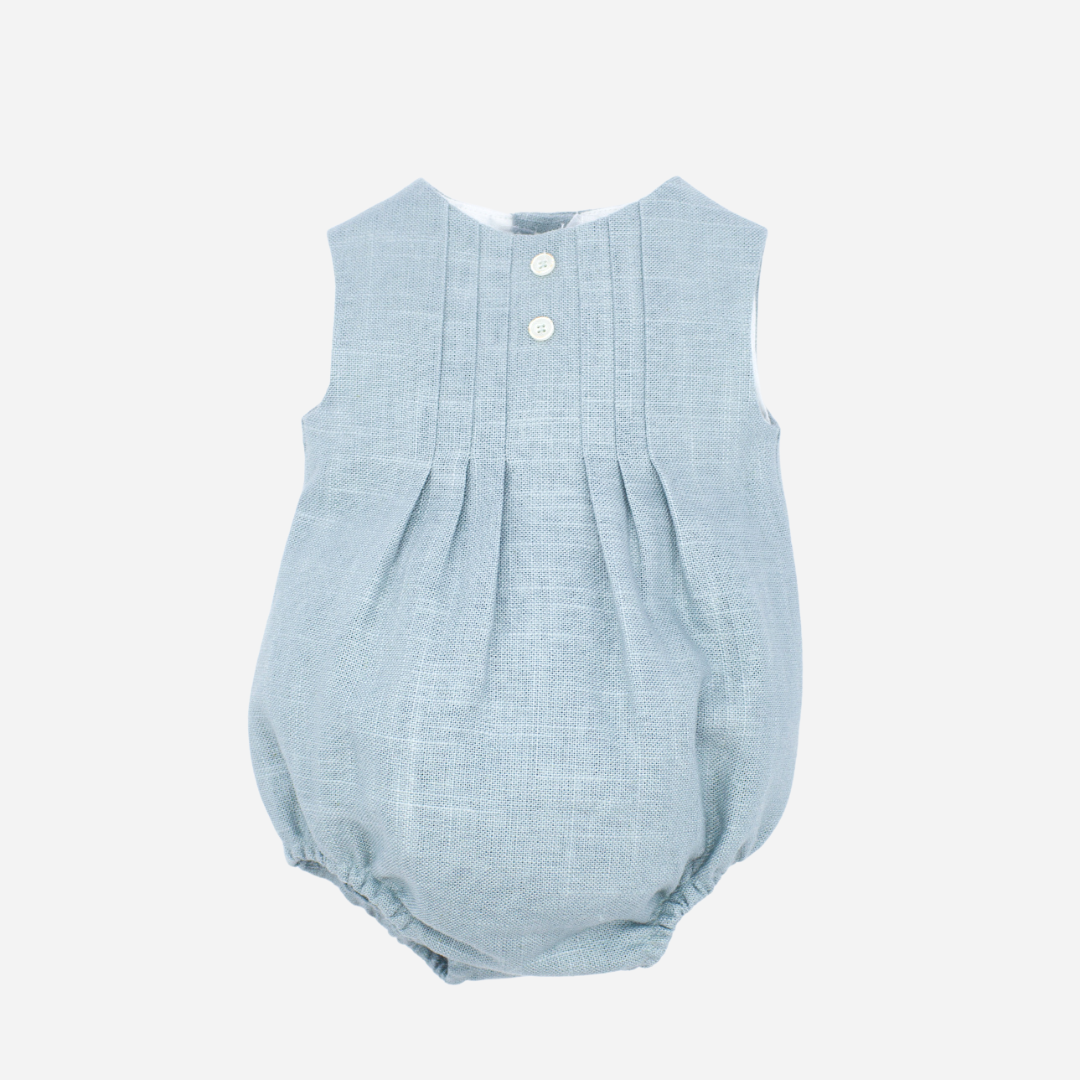 Sold at Bombon shop, designed by Fina Ejerique brand, green linen pleated baby romper perfect for spring and summer. Front view