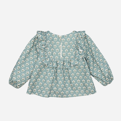 Sold at Bombon shop, designed by Fina Ejerique, a green floral viyella baby blouse with ruffled yoke and long sleeves, styled to pair with green corduroy shorts. back