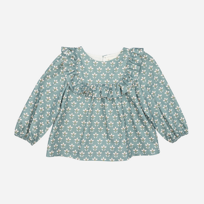 Sold at Bombon shop, designed by Fina Ejerique, a green floral viyella baby blouse with ruffled yoke and long sleeves, styled to pair with green corduroy shorts. front