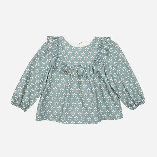 Sold at Bombon shop, designed by Fina Ejerique, a green floral viyella baby blouse with ruffled yoke and long sleeves, styled to pair with green corduroy shorts. front