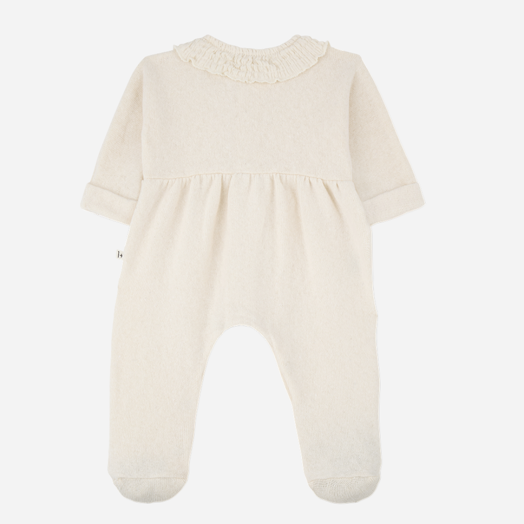 Sold at Bombon shop, designed by 1+ in the family — ivory baby jumpsuit with smocked Peter Pan collar, front buttons, and footed legs. back