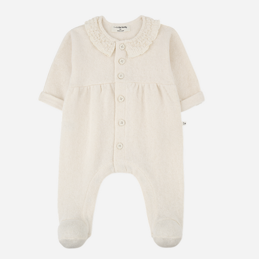 Sold at Bombon shop, designed by 1+ in the family — ivory baby jumpsuit with smocked Peter Pan collar, front buttons, and footed legs. front
