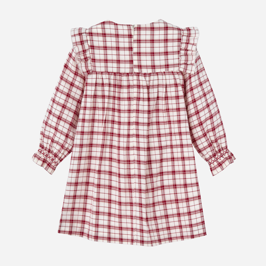Sold at Bombon shop, designed by Paz Rodriguez, baby and toddler red plaid dress with white embroidered holly collar and ruffle details from the Acebo holiday collection.
