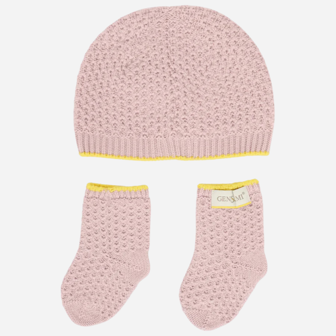 Sold at Bombon and designed by Gensami, a pink knit baby hat and booties set with yellow detailing.