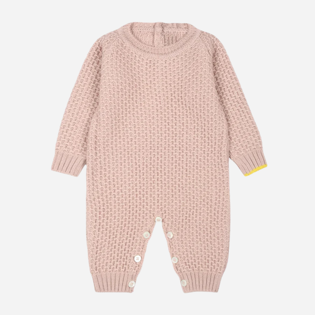 Sold at Bombon and designed by Gensami, a pink cotton knit baby jumpsuit with textured stitching and yellow cuff detail.