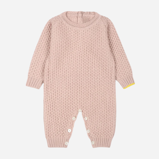 Sold at Bombon and designed by Gensami, a pink cotton knit baby jumpsuit with textured stitching and yellow cuff detail.