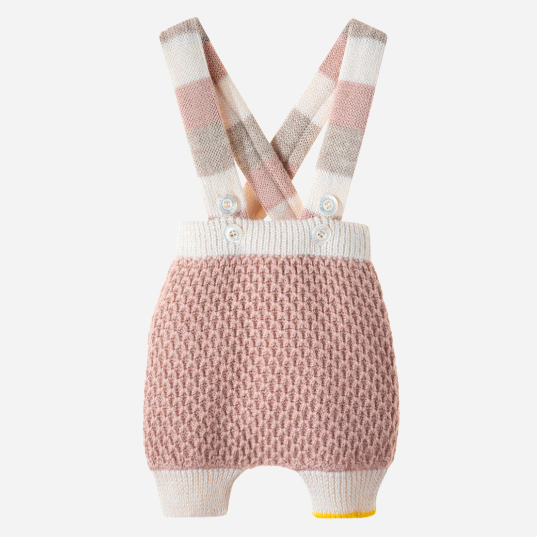Sold at Bombon and designed by Gensami, a pink knit baby bloomer with a textured pattern, striped suspenders in soft beige and blush tones, and a yellow trim detail at the leg.