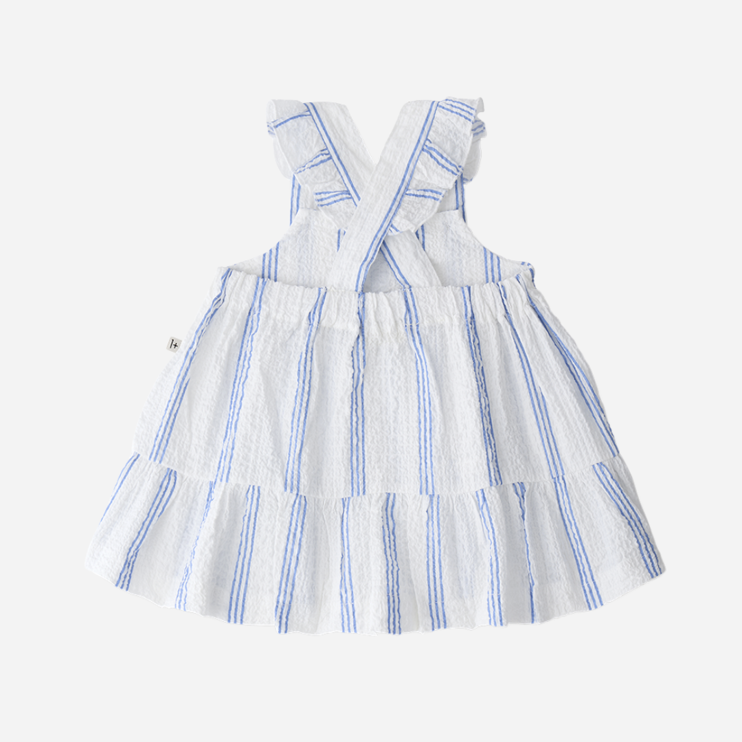 Sold at Bombon Shop, designed by 1+ in the family, ultramarine striped baby dress with adjustable straps and softly gathered skirt.