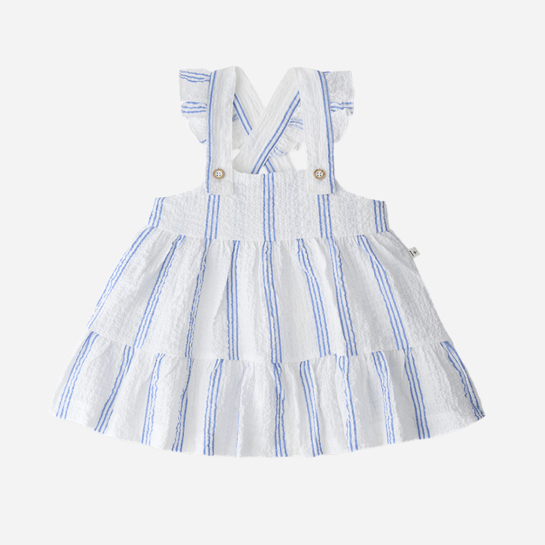 Sold at Bombon Shop, designed by 1+ in the family, ultramarine striped baby dress with adjustable straps and softly gathered skirt.