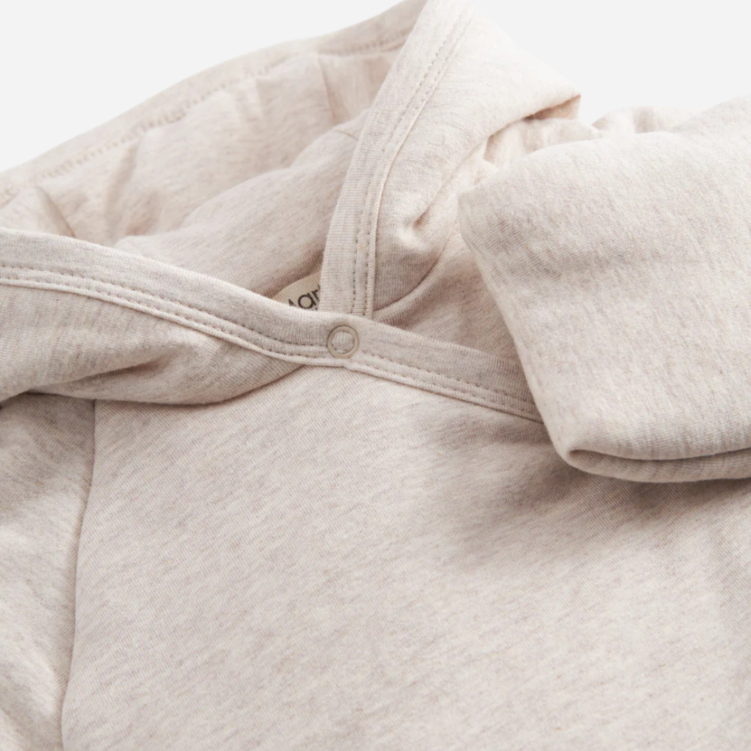 Sold at Bombon shop, designed by MarMar Copenhagen — beige organic cotton baby jacket with hood and side tie closure.