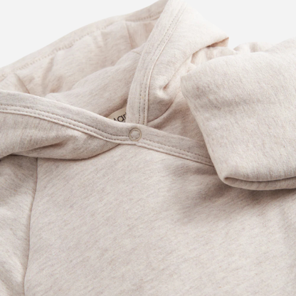 Sold at Bombon shop, designed by MarMar Copenhagen — beige organic cotton baby jacket with hood and side tie closure.