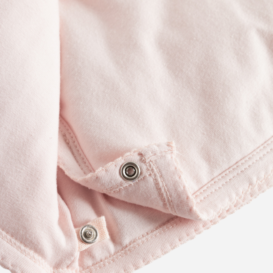 Sold at Bombon shop, designed by MarMar Copenhagen — blush pink organic cotton baby jacket with hood and side tie closure.