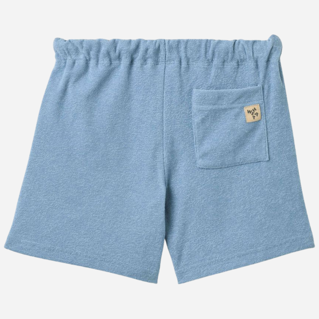Sold at Bombon Shop, designed by Wheat, faded denim organic cotton jersey shorts with elastic waistband and soft washed finish.