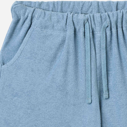 Sold at Bombon Shop, designed by Wheat, faded denim organic cotton jersey shorts with elastic waistband and soft washed finish.