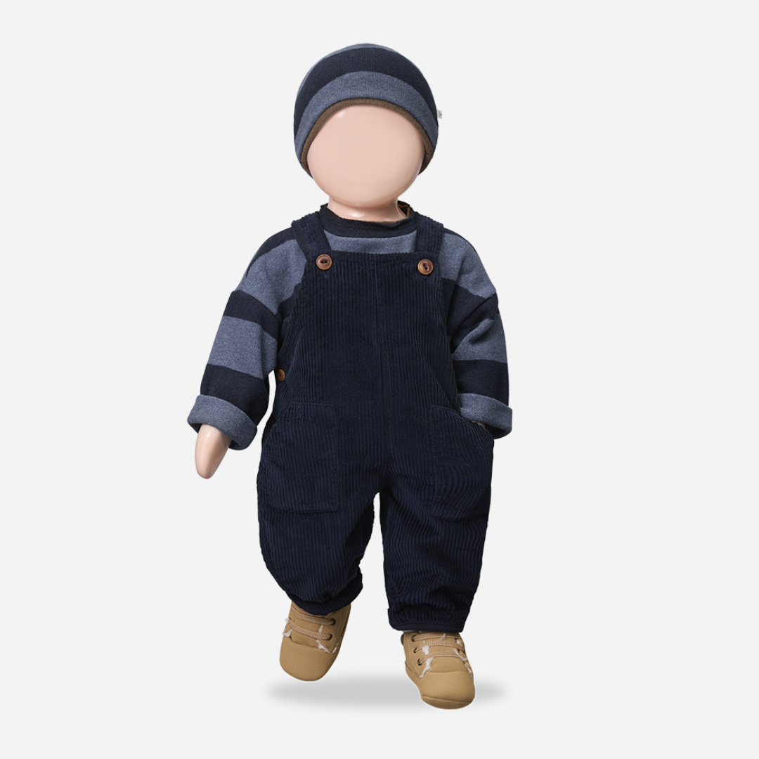 Doll wearing navy blue overalls, striped shirt, and hat on a white background