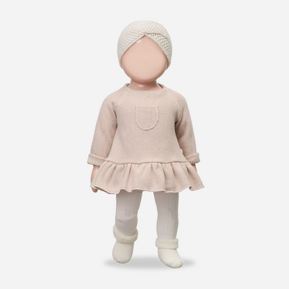 Baby doll wearing a beige outfit with a matching turban on a white background