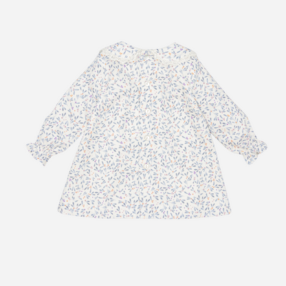 Sold at Bombon shop, designed by Fina Ejerique, a white baby dress with blue, lilac, and peach leaf print, lace-trim collar, blue buttons, and long sleeves. back