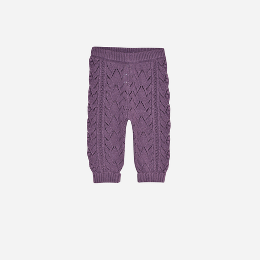 Sold at Bombon shop, these baby girl knit pants by The New Society come in a lilac tone with an all-over pointelle pattern, ribbed cuffs, and a comfortable elastic waistband for a cozy and sweet everyday essential. front