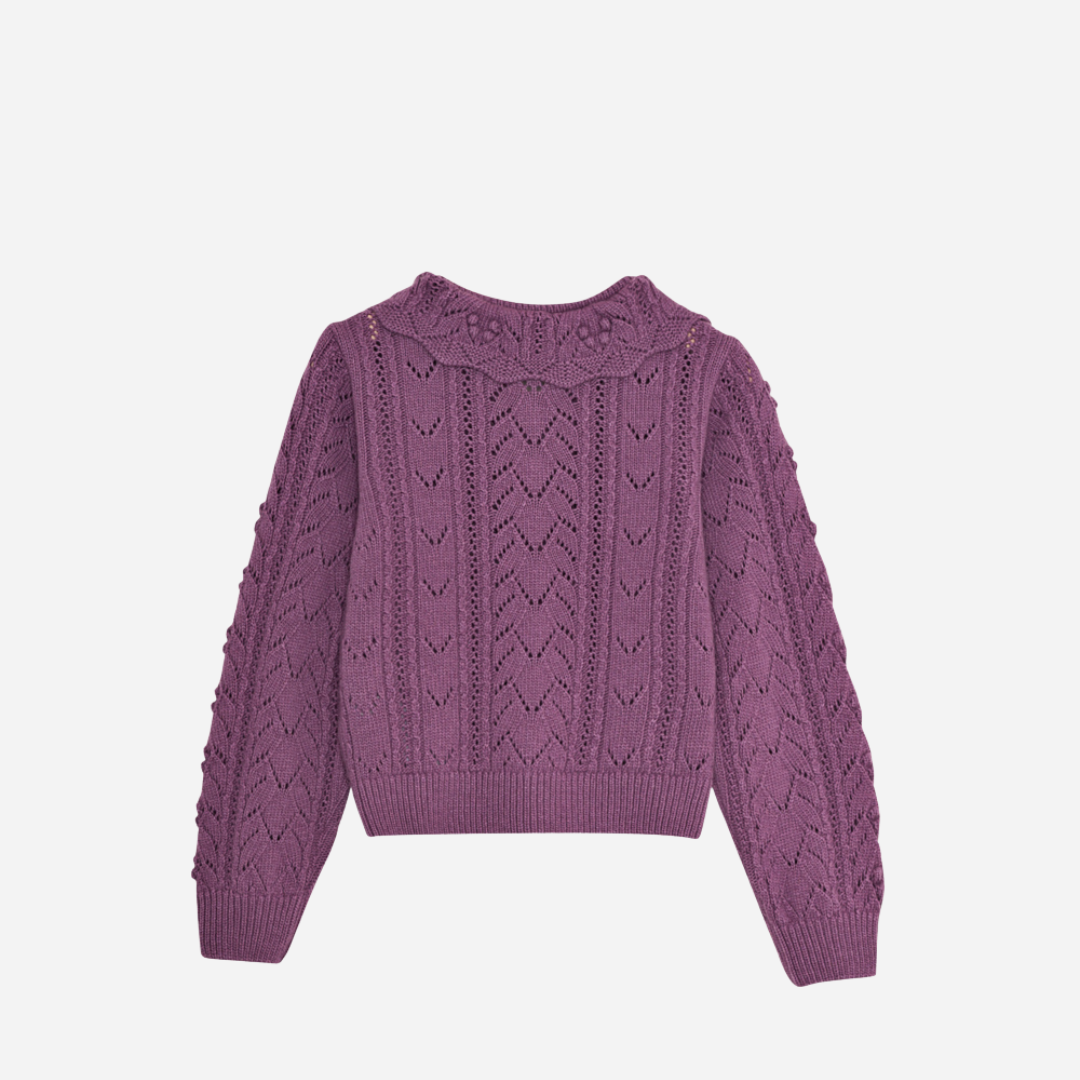 Sold at Bombon shop, this girls’ cardigan by The New Society features a rich lilac hue with an intricate pointelle knit pattern, scalloped Peter Pan collar, and front button closure—offering a refined and feminine layer for cooler days. back