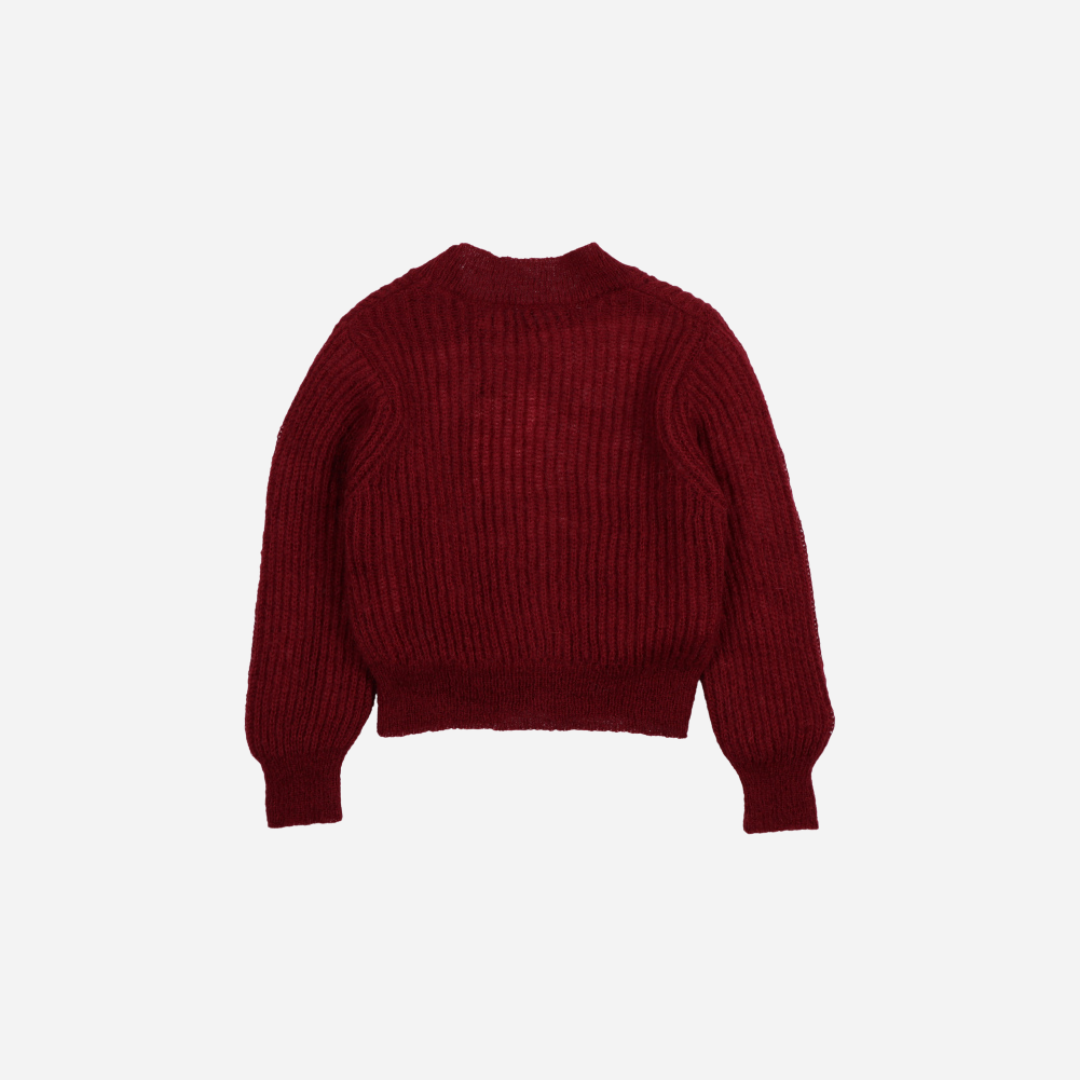 Sold at Bombon shop, this girls’ cardigan by The New Society comes in a rich burgundy knit with ribbed texture, heart-shaped buttons, and a cozy, slightly cropped fit—perfect for layering with a sweet, stylish touch. back