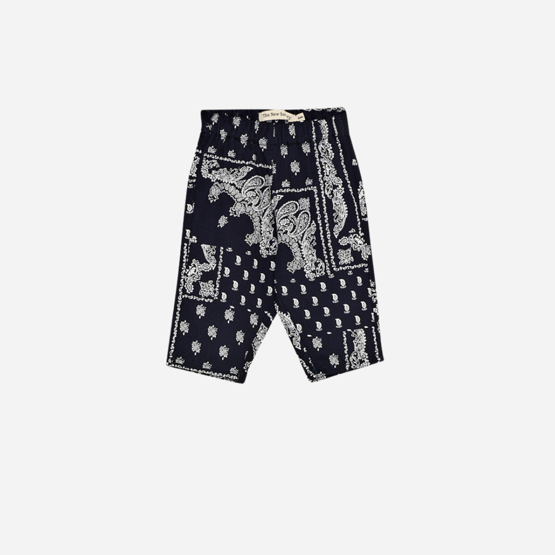 Sold at Bombon shop, these baby and toddler boy pants by The New Society feature a matching navy and white bandana print with an elastic waistband for an easy, comfortable fit—perfect for pairing with the coordinated shirt or mixing with basics. baby version, front