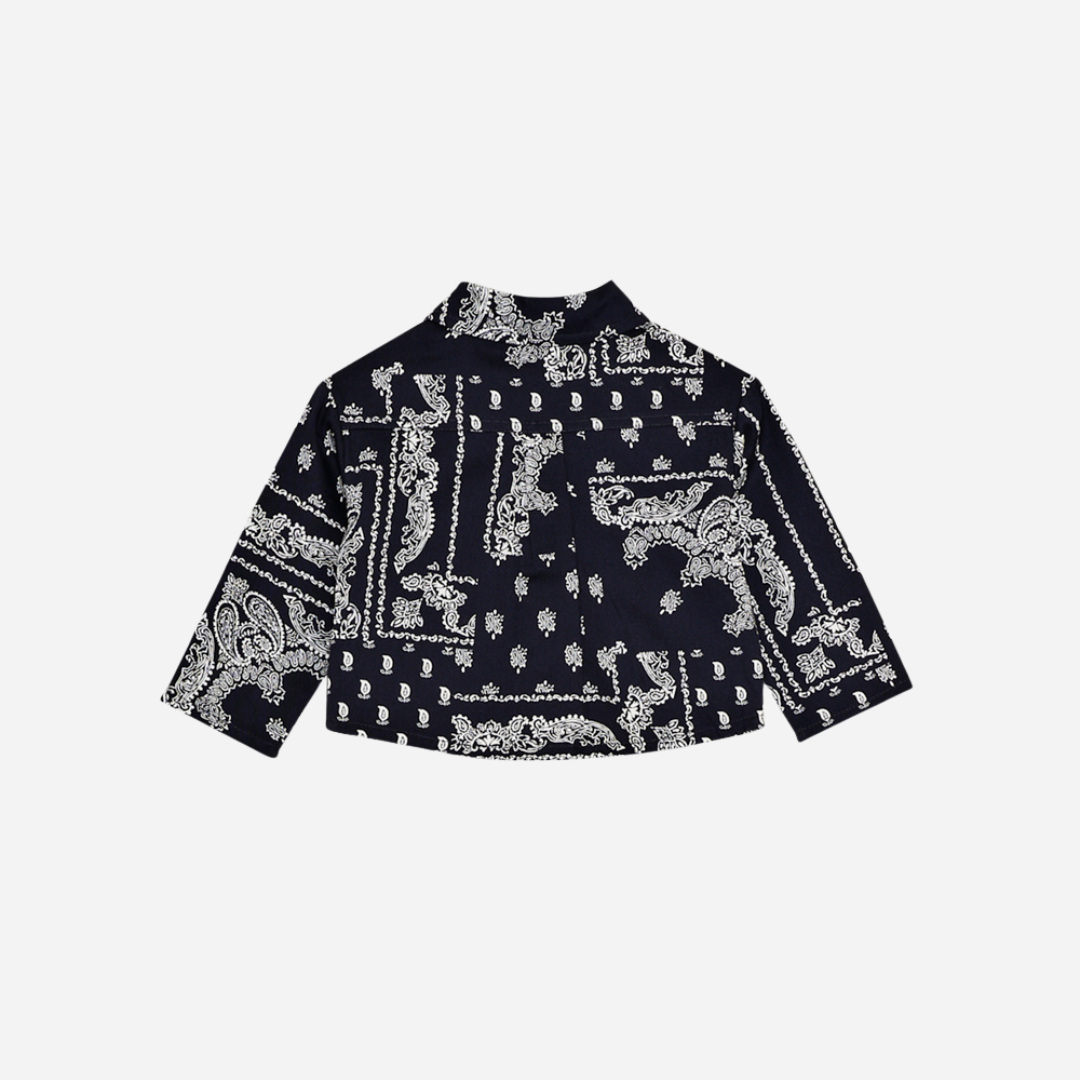 Sold at Bombon shop, this baby and toddler boy shirt by The New Society features a bold navy and white bandana-style print, long sleeves, front buttons, and a chest pocket embroidered with “TNS” for a stylish, laid-back look. baby version, back
