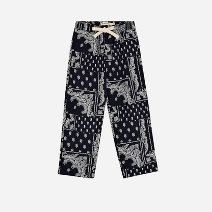 Sold at Bombon shop, these baby and toddler boy pants by The New Society feature a matching navy and white bandana print with an elastic waistband for an easy, comfortable fit—perfect for pairing with the coordinated shirt or mixing with basics. toddler version, front