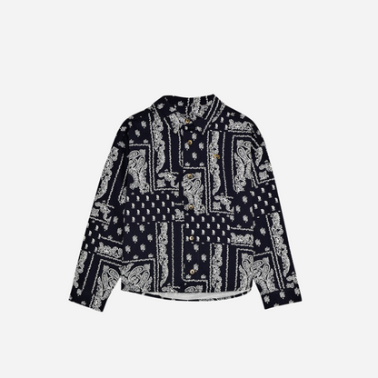 Sold at Bombon shop, this baby and toddler boy shirt by The New Society features a bold navy and white bandana-style print, long sleeves, front buttons, and a chest pocket embroidered with “TNS” for a stylish, laid-back look. toddler version, front