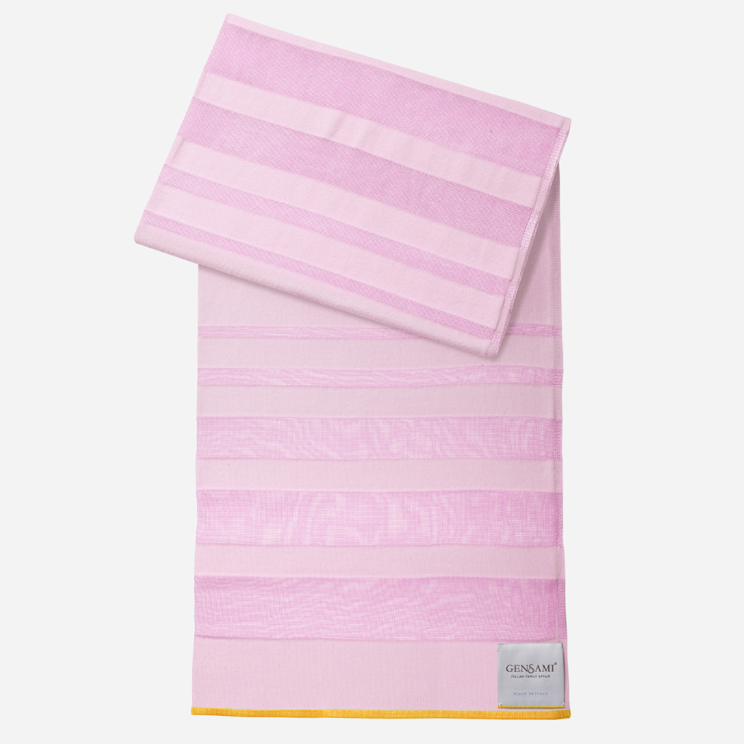 Sold at Bombon and designed by Gensami, a pink newborn layette set featuring a knit jumpsuit, hat, socks, and matching blanket with yellow stripe accents