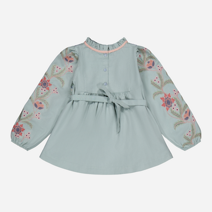 sold at Bombon shop, designed by Bachaa, Blouse/Short dress, Blue color, Organic cotton twill (167 g/m²), Plain lining in organic cotton voile, Long embroidered and elasticated sleeves, Smocked chest, Ruffled collar, Tone-on-tone buttons and belt at the back. Back view