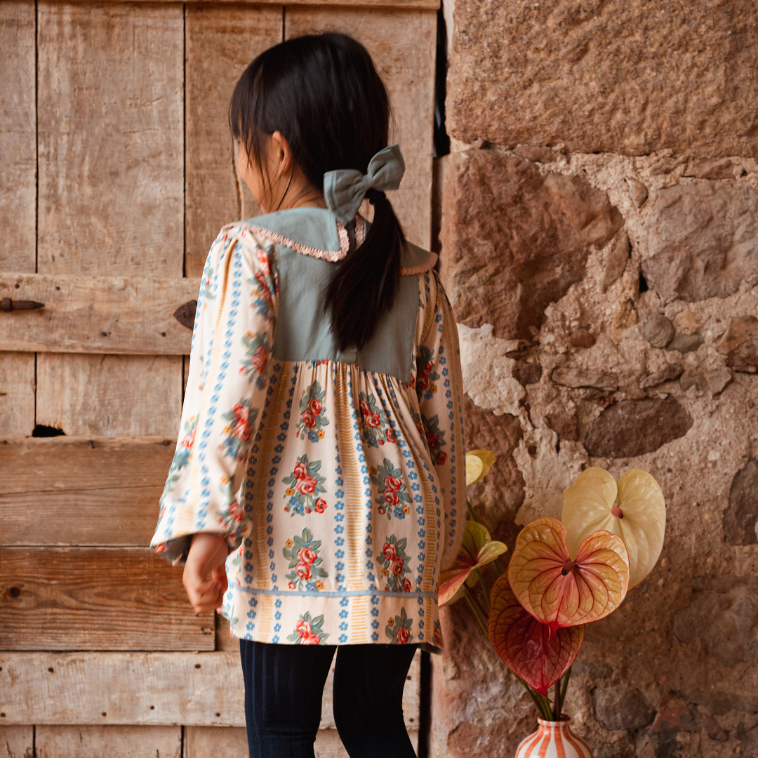 sold at Bombon shop, designed by Bachaa Blouse, 100% ECOVERO® Viscose, Block Print, Hand embroidered and lace trimmed collar, Hand embroidery on the sleeves, Contrasting tape, Gathers at the front and back, Long elasticated sleeves, Contrasting buttons and yoke at the back. model view