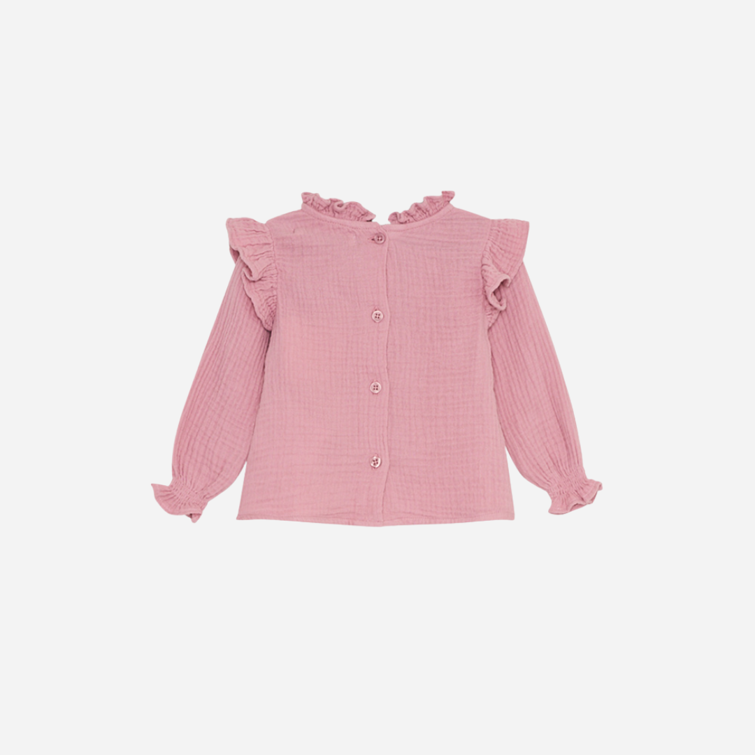 Sold at Bombon shop, this baby girl blouse by The New Society features a soft pink cotton gauze fabric, delicate ruffle details at the shoulders and cuffs, and an embroidered floral motif on the chest for a sweet, timeless look. back